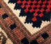 Handwoven wool rug detail in red, navy and cream