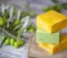 Stack of three olive-oil soap bars on burlap with olive branches